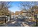 Community entrance gate with multiple parked cars, with surrounding trees at 1101 Collier Nw Rd # V6, Atlanta, GA 30318