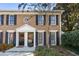 Charming brick townhome featuring black shutters and front door wreath at 1101 Collier Nw Rd # V6, Atlanta, GA 30318