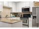 Well-lit kitchen featuring stone countertops and stainless appliances at 1101 Collier Nw Rd # V6, Atlanta, GA 30318