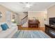 Cozy living room featuring a piano, staircase, and stylish furnishings at 1101 Collier Nw Rd # V6, Atlanta, GA 30318