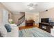 Cozy living room featuring a piano, staircase, and stylish furnishings at 1101 Collier Nw Rd # V6, Atlanta, GA 30318