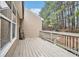 A wooden back deck is set on the back of this tan sided house at 113 Ambridge Ct, Lawrenceville, GA 30044