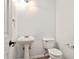 This bathroom features a pedestal sink and toilet at 113 Ambridge Ct, Lawrenceville, GA 30044