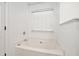 Bathroom with a white soaking tub and window at 113 Ambridge Ct, Lawrenceville, GA 30044