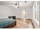 A bedroom with wood-look floors, a ceiling fan and multiple doors and windows at 113 Ambridge Ct, Lawrenceville, GA 30044
