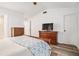 The bedroom features hard surface flooring, neutral paint and television at 113 Ambridge Ct, Lawrenceville, GA 30044