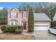 Inviting two-story home with red shutters and door, plus a two-car garage at 113 Ambridge Ct, Lawrenceville, GA 30044