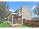 An exterior view of this two story home shows an elevated garden and covered patio at 113 Ambridge Ct, Lawrenceville, GA 30044