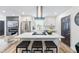 Well-lit kitchen featuring a quartz island with seating, sleek stainless steel refrigerator, and modern finishes at 1147 Graymont Sw Dr, Atlanta, GA 30310