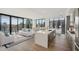 Bright and airy living room with floor-to-ceiling windows and modern kitchen with island at 2425 Peachtree Ne Rd # 510, Atlanta, GA 30305