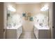 Bathroom featuring dual vanities, tile floors, and decorative wall art at 907 Hannah Ct, Loganville, GA 30052