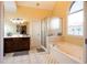 Well-lit bathroom featuring tile floors, double sink, and a glass enclosed shower at 907 Hannah Ct, Loganville, GA 30052