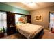 Cozy bedroom showcasing a large armoire, decorative art, and comfortable furnishings at 907 Hannah Ct, Loganville, GA 30052