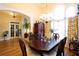 Elegant dining room features a grand table, chandelier, and arched windows, perfect for entertaining at 907 Hannah Ct, Loganville, GA 30052