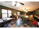 Spacious game room features tile floors, windows, and space for recreation, games, and entertaining at 907 Hannah Ct, Loganville, GA 30052