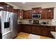 Well-equipped kitchen showcases stainless steel appliances, wooden cabinets, and granite countertops at 907 Hannah Ct, Loganville, GA 30052