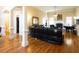 Bright living room featuring hardwood floors, decorative columns, fireplace, and ample seating at 907 Hannah Ct, Loganville, GA 30052