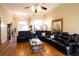 Bright living room features hardwood floors, elegant lighting, and a comfortable sectional sofa for relaxation at 907 Hannah Ct, Loganville, GA 30052