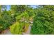 Overhead view of a cozy single-story home with a red roof surrounded by lots of green trees at 3293 Valleydale Sw Dr, Atlanta, GA 30311