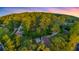 Expansive aerial view of a charming home nestled among mature trees in a tranquil, lush neighborhood at 3293 Valleydale Sw Dr, Atlanta, GA 30311