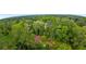 Wide aerial view of home and surrounding area with lots of tree coverage and neighboring homes and apartments at 3293 Valleydale Sw Dr, Atlanta, GA 30311