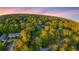 Beautiful aerial scene highlighting a cozy home surrounded by a lush, green forest landscape at 3293 Valleydale Sw Dr, Atlanta, GA 30311