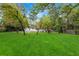 Backyard view showing the lush green lawn with mature trees at 3293 Valleydale Sw Dr, Atlanta, GA 30311