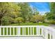 Backyard view from the deck, showing lush green grass and mature trees at 3293 Valleydale Sw Dr, Atlanta, GA 30311