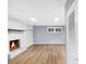 Finished basement with a charming white brick fireplace and wood-look flooring at 3293 Valleydale Sw Dr, Atlanta, GA 30311