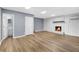 Finished basement featuring a brick fireplace, new wood-look flooring, and a nearby bathroom at 3293 Valleydale Sw Dr, Atlanta, GA 30311