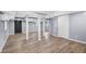 Finished basement with modern flooring, neutral paint, and support beams at 3293 Valleydale Sw Dr, Atlanta, GA 30311
