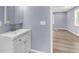 Bathroom with a white vanity with modern fixtures and view into the next room at 3293 Valleydale Sw Dr, Atlanta, GA 30311