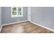 Bedroom featuring new wood-look floors, neutral walls, double window, and white trim at 3293 Valleydale Sw Dr, Atlanta, GA 30311