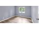 Neutral bedroom featuring new wood-look floors, neutral walls and a double window at 3293 Valleydale Sw Dr, Atlanta, GA 30311