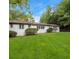 Classic home featuring a brick facade, white trim, well manicured lawn, and mature shrubs at 3293 Valleydale Sw Dr, Atlanta, GA 30311