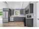 Modern kitchen featuring gray cabinets, stainless steel appliances, and granite countertops at 3293 Valleydale Sw Dr, Atlanta, GA 30311