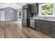 Contemporary kitchen with gray cabinetry, stainless steel refrigerator, and convenient dishwasher at 3293 Valleydale Sw Dr, Atlanta, GA 30311