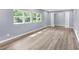Inviting living space with large windows and natural light illuminating the wood-look flooring at 3293 Valleydale Sw Dr, Atlanta, GA 30311