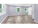 Neutral bedroom featuring new wood-look floors, neutral walls, and 2 windows with white trim at 3293 Valleydale Sw Dr, Atlanta, GA 30311