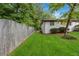 Well manicured side yard featuring a white brick facade and privacy fence at 3293 Valleydale Sw Dr, Atlanta, GA 30311