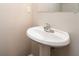Simple bathroom with pedestal sink and mirror at 7077 Ravenwood Ln, Lithonia, GA 30038