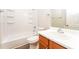 Clean bathroom with tub, shower, and wood vanity at 7077 Ravenwood Ln, Lithonia, GA 30038