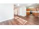 Open concept dining area with hardwood floors and kitchen views at 7077 Ravenwood Ln, Lithonia, GA 30038