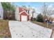 Front view of house, long driveway, and mature trees at 7077 Ravenwood Ln, Lithonia, GA 30038