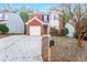 Brick two-story house with attached garage and driveway at 7077 Ravenwood Ln, Lithonia, GA 30038