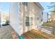 Tan vinyl sided home with private backyard at 7077 Ravenwood Ln, Lithonia, GA 30038