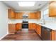 Kitchen with wood cabinets, stainless steel appliances, and white countertops at 7077 Ravenwood Ln, Lithonia, GA 30038