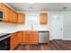 Kitchen with wood cabinets, stainless steel appliances, and white countertops at 7077 Ravenwood Ln, Lithonia, GA 30038