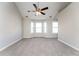 Large main bedroom with tray ceiling, ceiling fan, and carpet at 7077 Ravenwood Ln, Lithonia, GA 30038