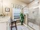 Bathroom with tile floors, marble countertops, decorative plant, and glass-enclosed shower with seat at 595 Everton Pl, Grayson, GA 30017